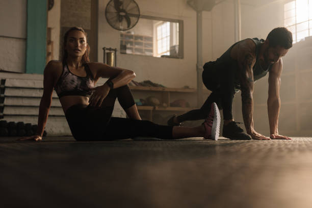 istock Fitness people doing stretching warmup at gym 915801132