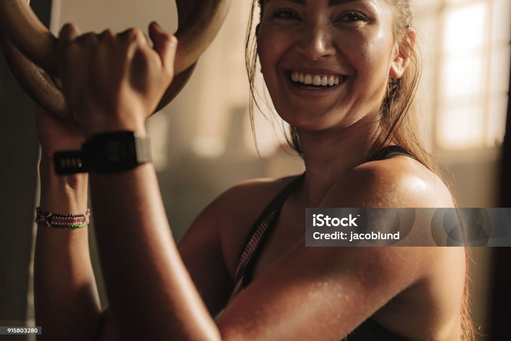 Lächelnde Frau mit Gymnastik Ringen trainieren - Lizenzfrei Trainingsraum - Freizeiteinrichtung Stock-Foto