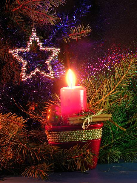 istock red burning candle and Christmas decoration 91580407