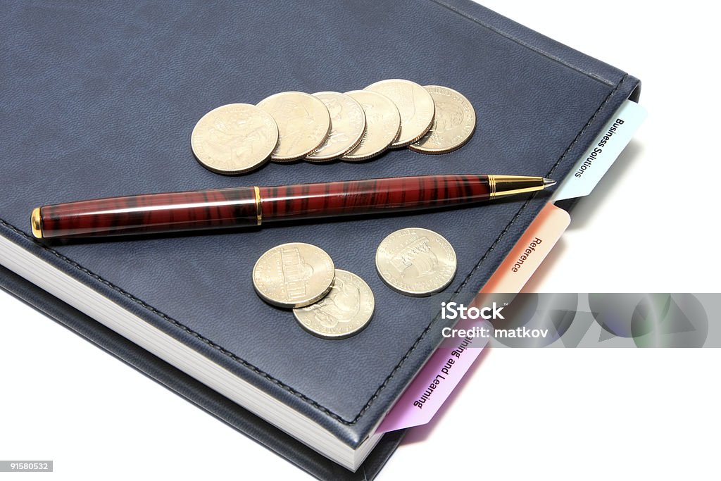 diary, pen and coins on white  Arrangement Stock Photo