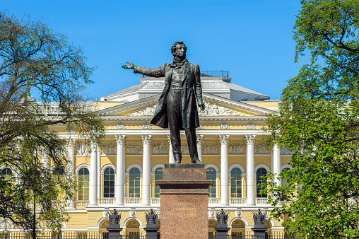 St. Petersburg, Russia - May 12, 2016: Monument to the great Russian poet Alexander Pushkin on Arts Square, Sculptor M. Anikushin, 1957. Russian Museum on the background.