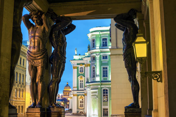 ST PETERSBURG, RUSSIA - February 27, 2016: Statues of Atlants near Palace square (Dvortsovaya square) and Hermitage (Winter Palace). Palace square the city's main square with landmarks and historic buildings.