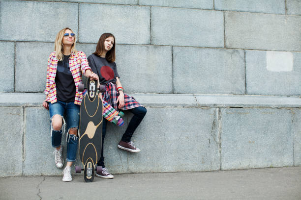 Mother and daughter skateboarding