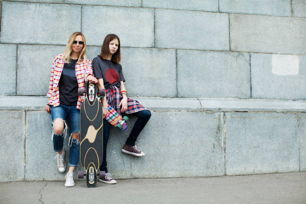 istock Mother and daughter skateboarding 915809778