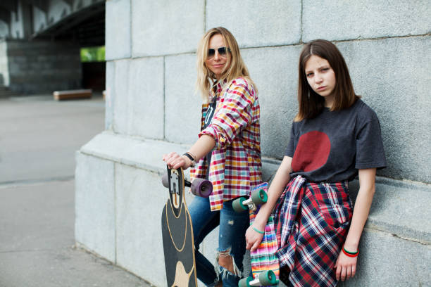 istock Mother and daughter skateboarding 915809798