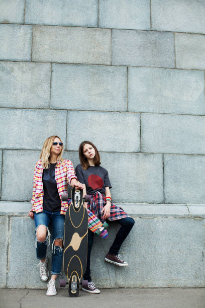 istock mother and daughter walking together 915809802