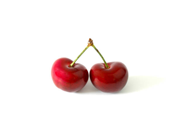istock Heart shaped two cherries isolated on white background 915810496