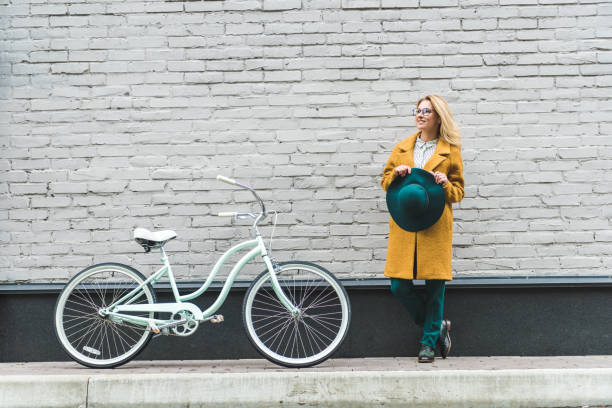 istock woman at wall with bicycle 915815250