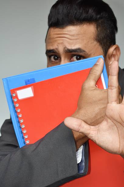 mature man in office opening a file with documents