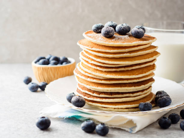 istock Pancakes with blueberries and sugar on grey stone background. 915819356