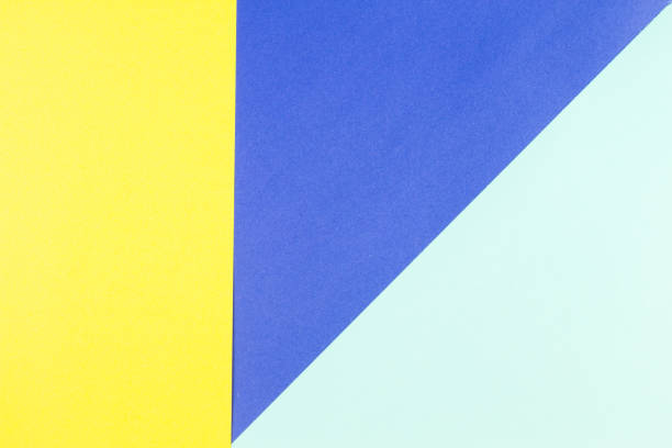 istock Colored papers geometry flat composition background with yellow and blue tones 915822208