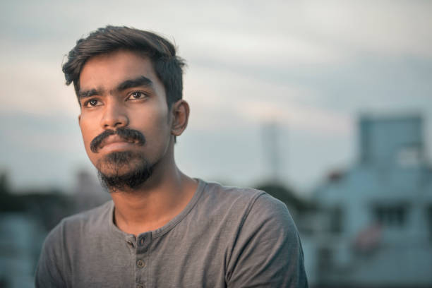 istock Portrait of Indian young man in evening light 915822768