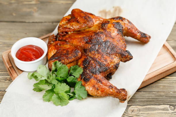 istock grilled chicken. Serving on a wooden Board on a rustic table. Barbecue restaurant menu, a series of photos of different meats 915825312