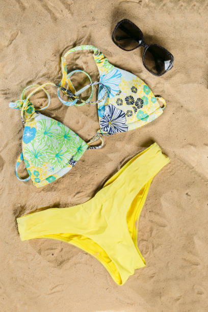 istock Summer concept - bathing suit, sunglasses, flip flops, towel 915825452
