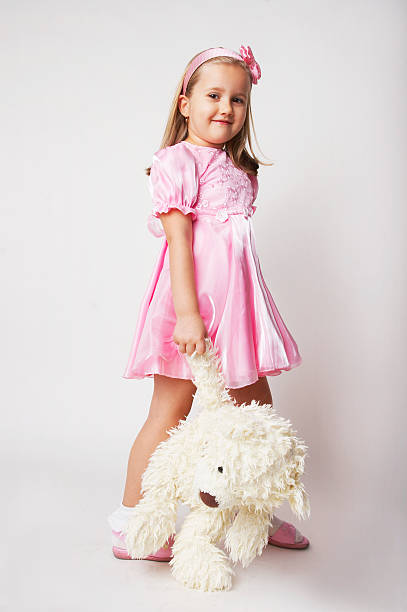 istock young girl in pink on light background with teddy bear 91582613