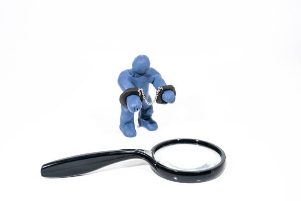 istock Small blue figure in handcuffs. Made from Play Clay. 915826166