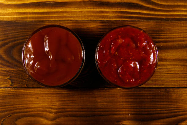 istock Tomato sauces on wooden table. Top view 915827374