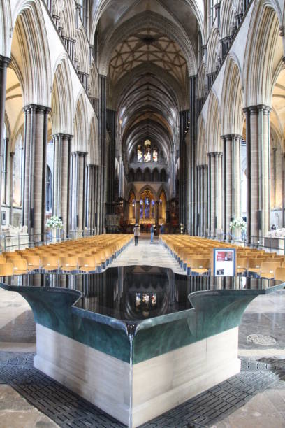 Salisbury Cathedral Font Roof and columns reflected in the water of the font in Salisbury cathedral. baptismal font stock pictures, royalty-free photos & images