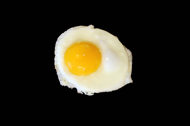istock Sunnyside up egg frying isolated on black 91583229