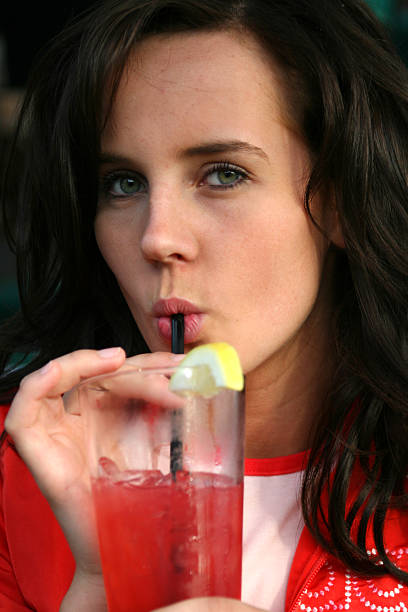 istock Young woman sipping on beverage 91583527