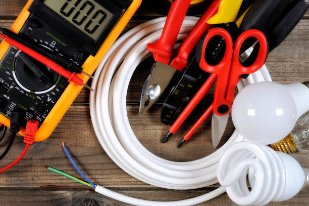 top view of work tools and electrical system components on antique wooden background. - household equipment light bulb compact fluorescent lightbulb lighting equipment imagens e fotografias de stock