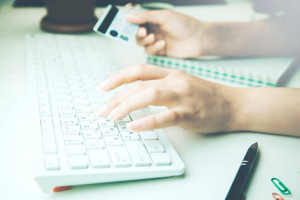 istock woman  holding credit card using laptop 915838592