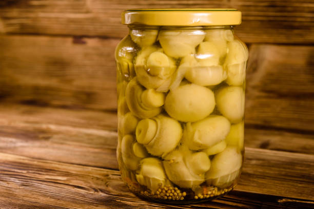 istock Jar with canned mushrooms on wooden table 915839858