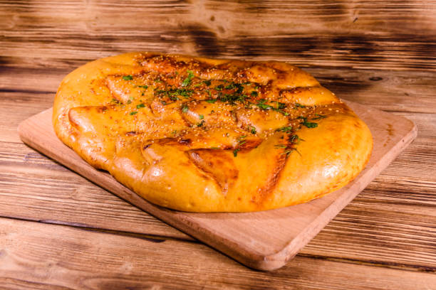 istock Pita bread with garlic on a wooden cutting board 915839890