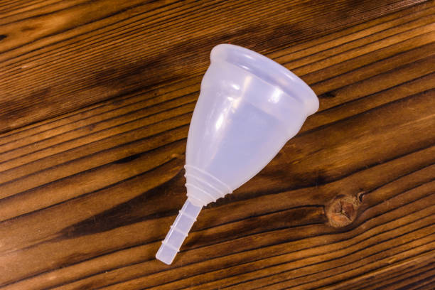 istock White menstrual cup on a wooden table 915839908