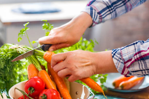 istock Cutting Fresh Carrots on Wooden Board 915845872