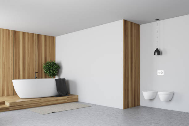 istock Tiled and white bathroom, tub and toilets 915849638
