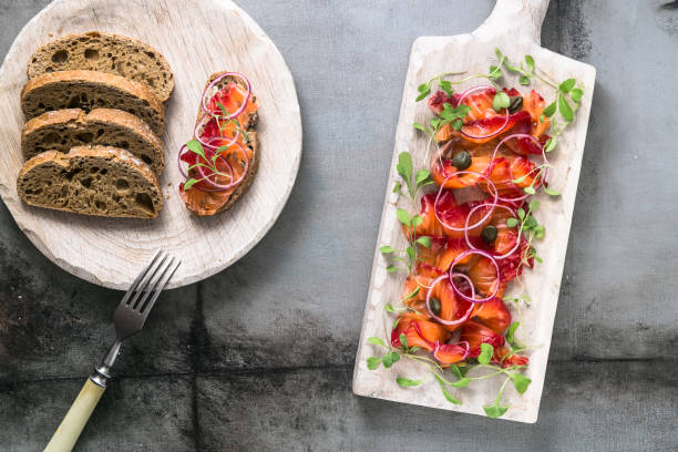Cured salmon with onion, greens and bread, scandinavian dish