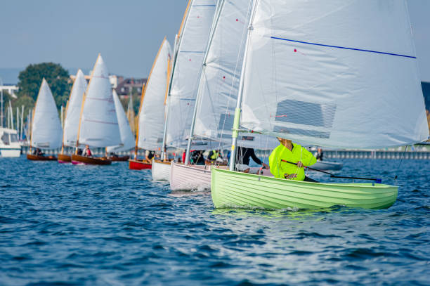12 foot dinghies line up for the start of a regatta