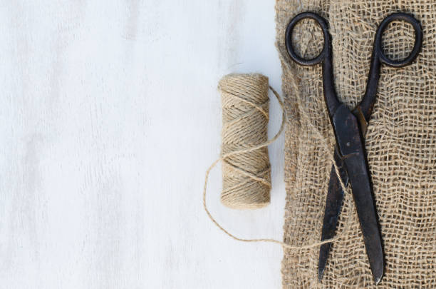 istock Old scissors, skein jute twine and burlap. 915864412