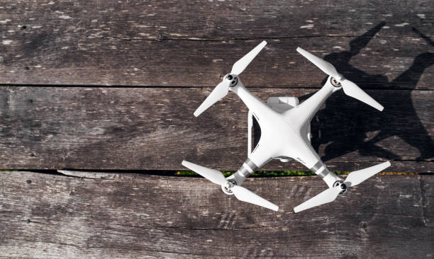 istock Top view of white drone standing on a wooden table. 915864420