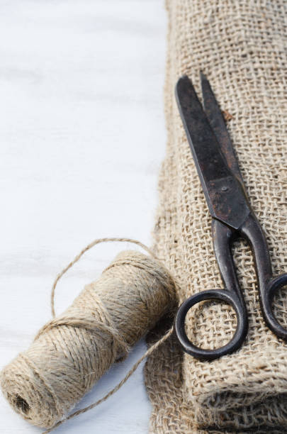 istock Old scissors, skein jute twine and burlap. 915864444
