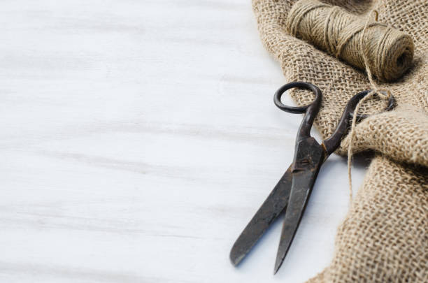 istock Old scissors, skein jute twine and burlap. 915864472
