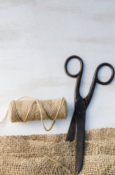 istock Old scissors, skein jute twine and burlap. 915864498