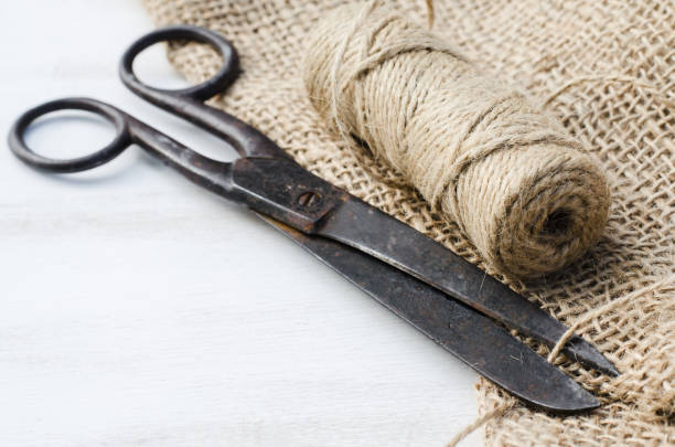 istock Old scissors, skein jute twine and burlap. 915864524