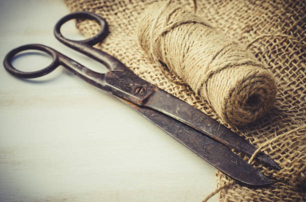 istock Old scissors, skein jute twine and burlap. 915864574