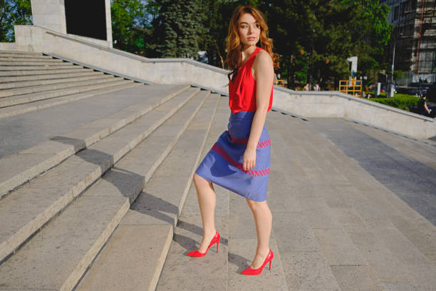 istock Beautiful woman walking up stairs 915864748