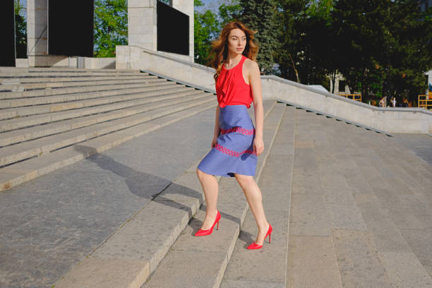 istock Beautiful woman walking up stairs 915864760