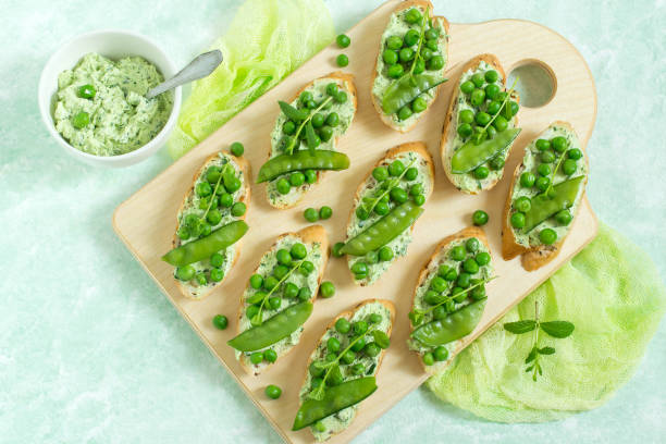 istock Fresh spring toast with cottage cheese and herbs, green peas and mint sprouts 915865308