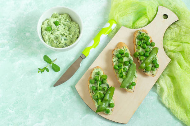 istock Fresh spring toast with cottage cheese and herbs, green peas and mint sprouts 915865320