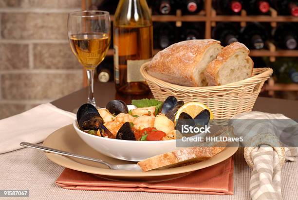 Bowl Of Seafood Soup With Wine And Rustic Bread Stock Photo - Download Image Now - Basket, Bowl, Bread