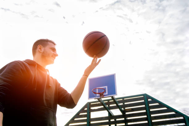 istock Fit man spinning a basketball 915871024