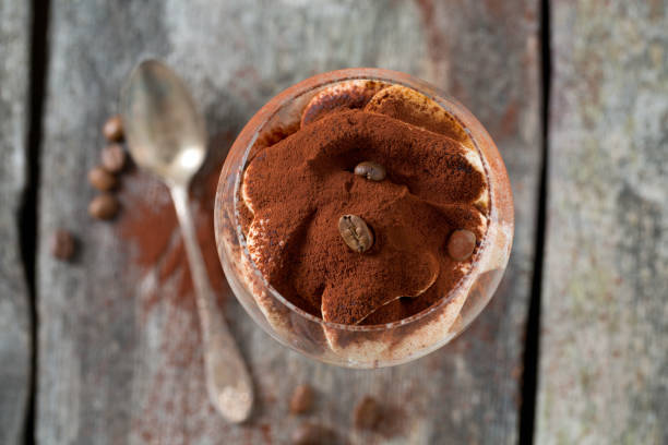 istock tiramisu in a vine glass on wooden surface 915875222