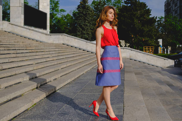 istock Beautiful woman posing on stairs 915875972