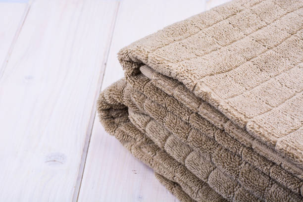 istock Terry towels brown on wooden table 915878432