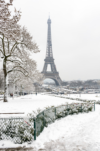 The Eiffel tower by a rare snowy day in Paris seen from the Trocadero garden.